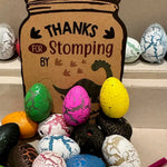 Colorful dinosaur-themed Easter eggs with a ‘Thanks for Stomping’ tag in the background.