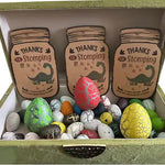 Colorful dinosaur-themed Easter eggs inside a box with ‘Thanks for Stomping’ tags.