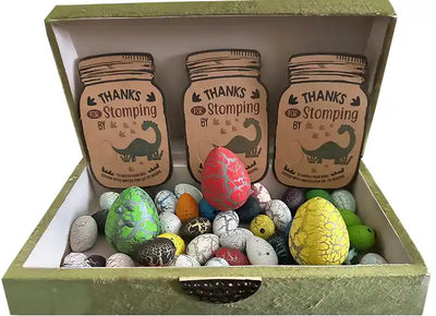 Colorful dinosaur-themed Easter eggs inside a box with ‘Thanks for Stomping’ tags.